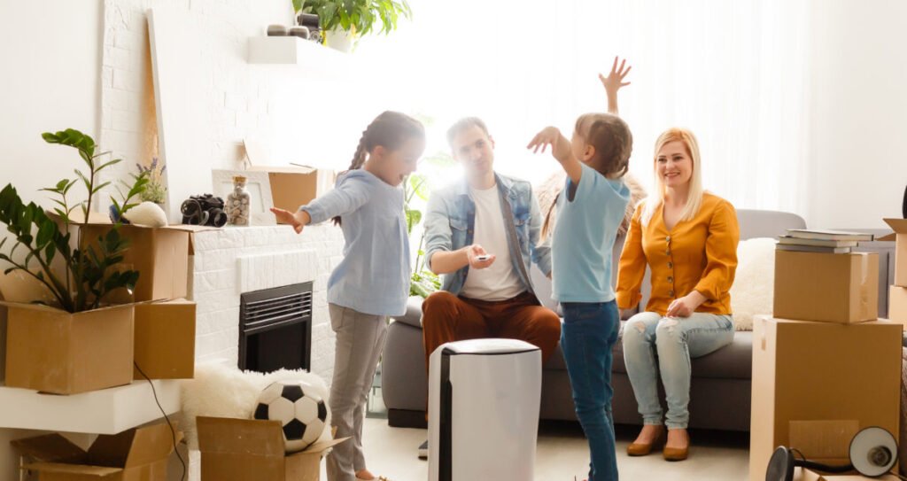 air purifier in living room with happy family moving to new apartment