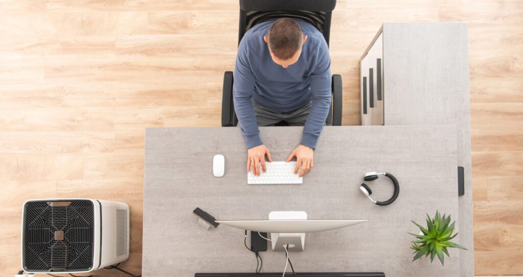 Home Office Worker in Front of Computer Top View
