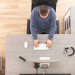 Home Office Worker in Front of Computer Top View