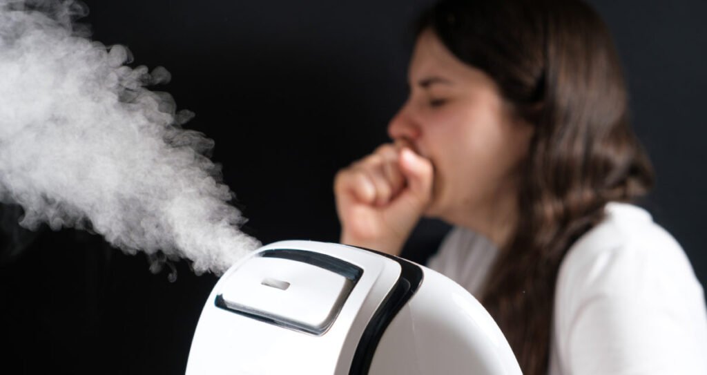 Humidifier and coughing woman in the background. Humidification of the air with cough and viral infections