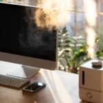 Close up of desktop air purifier and aroma oil diffuser on desk at home