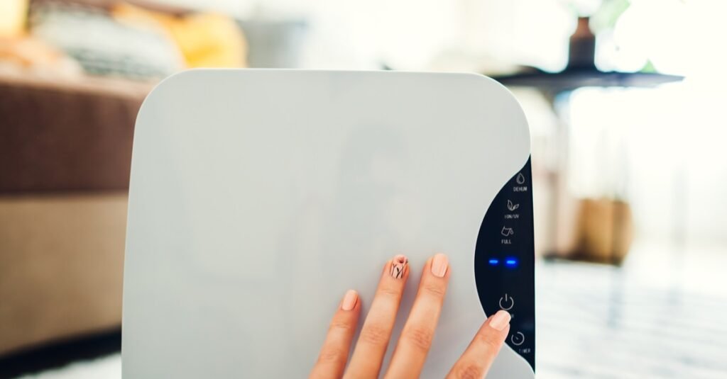 Woman turns dehumidifier on using touch panel