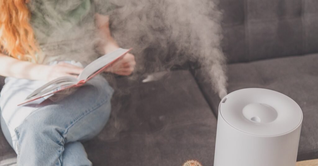 humidifier at home on table near woman reading on-sofa
