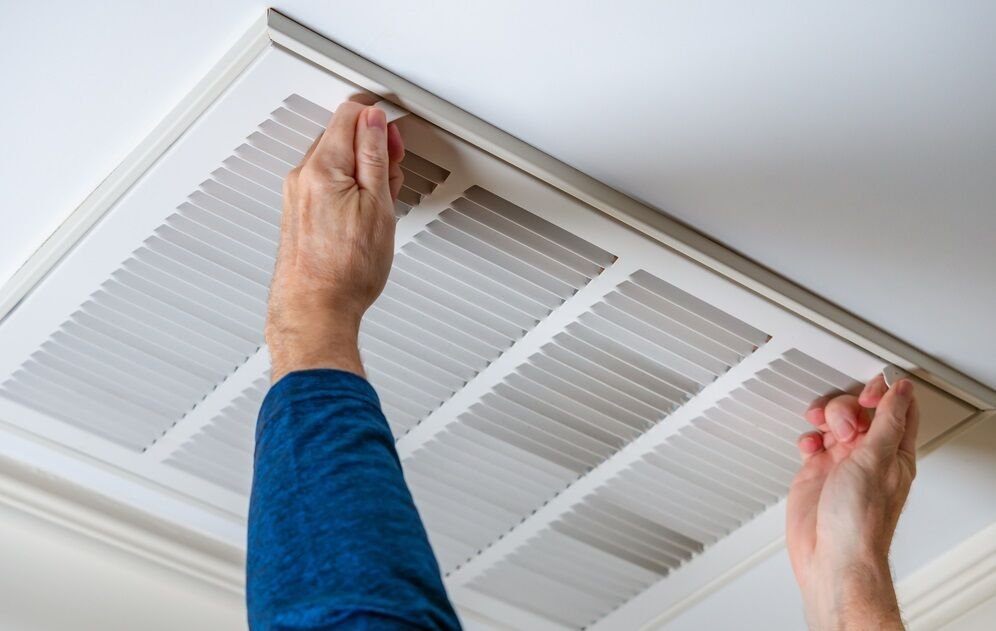 repair person opening ac duct